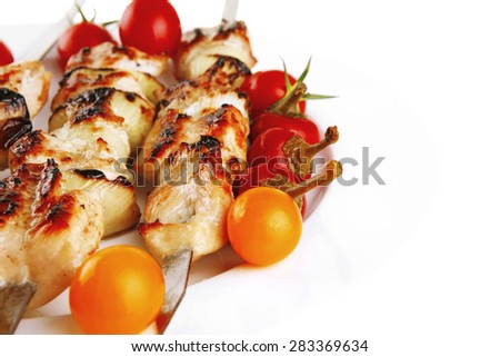 fresh turkey barbecue shish kebab served with tomatoes capers on platter isolated over white background