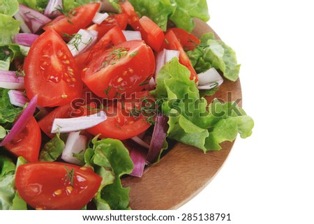 fresh raw vegetable salad with tomatoes and green lettuce on wooden plate isolated over white background