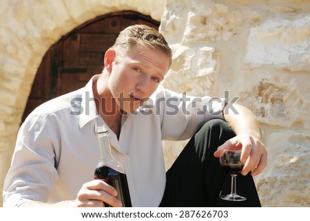 young happy white Caucasian man taste and enjoy red wine outdoor in in countryside