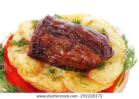 fresh roast beef meat chunk in transparent bowl over baked potatoes and tomatoves served with fill isolated over white background
