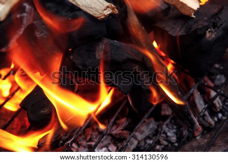 hot fire black wood charcoal in big round bbq