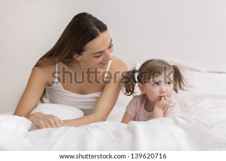 Dispute between a little girl and her mother in bedroom