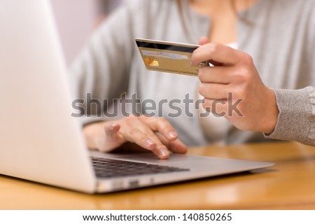 Close-Up Woman\'S Hands Holding A Credit Card And Using Computer Keyboard For Online Shopping