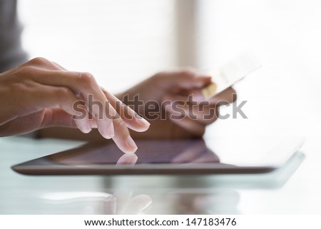 Woman Shopping Using Tablet Pc And Credit Card .Indoor.Close-Up