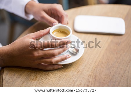 Woman drinking coffee in restaurant, cafe, cell phone