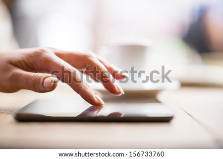 Close up of hands woman using her cell phone in restaurant cafe Close up of hands woman using her cell phone in restaurant cafe