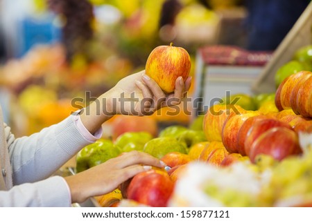 Woman Buys Fruits And Vegetables At A Market, Apple