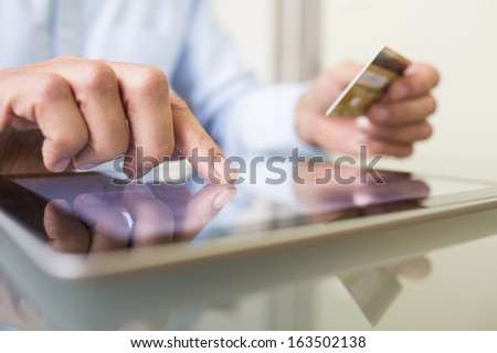 Man holding tablet pc and credit card indoor, Shopping Online