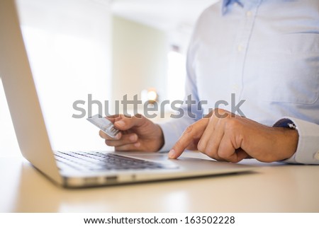 Man using credit card and laptop, On line Shopping.indoor