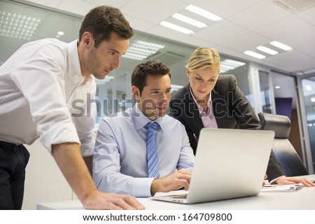 A business team of three in office and planning work A business team of three in office and planning work