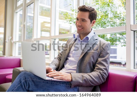 Handsome Businessman working with Laptop on sofa