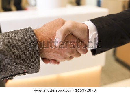 Handshake isolated on business office background