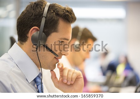 Call center team in the office on the phone with headset
