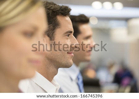 Group of business people at the office lined up, focus on man