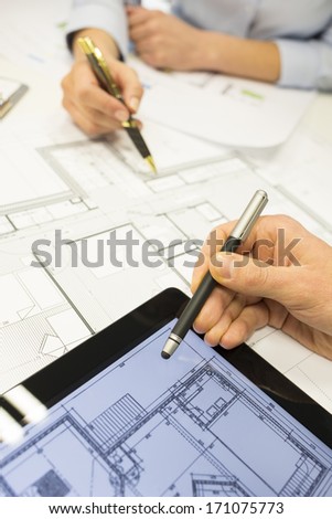 Close-up of Team architects working on construction project in office