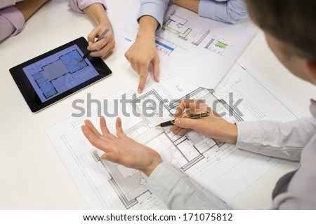 Close-Up Of Team Architects Working On Construction Project In Office