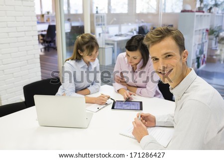 Portrait Of Smiling Businessman During A Meeting, Looking Camera