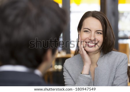 Portrait of beautiful woman during a lunch with a man in restaurant