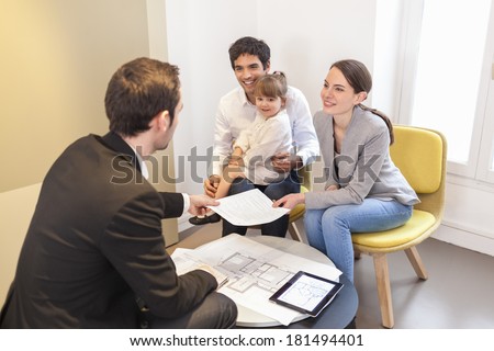 Young Family meeting real-estate agent to buy property