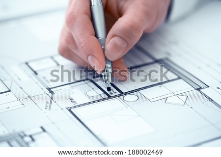 Architect Woman drawing on print construction project