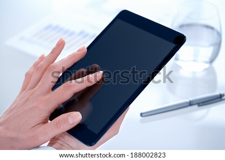 Businesswoman using tablet pc in office