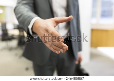 Businessman giving a hand in office