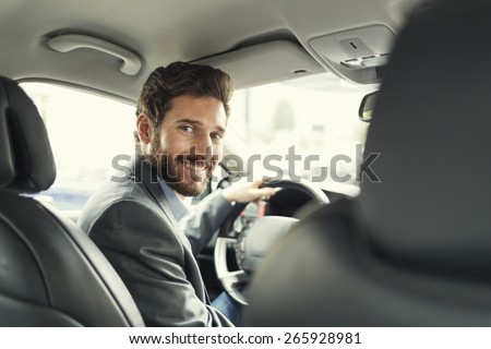 Portrait of man in his car. looking camera