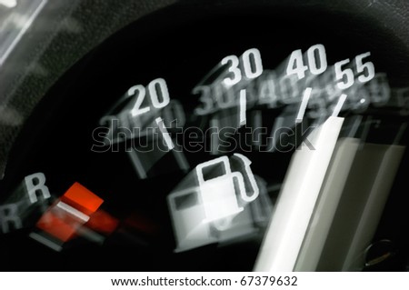 Fuel gauge of a car in dynamic motion blurr
