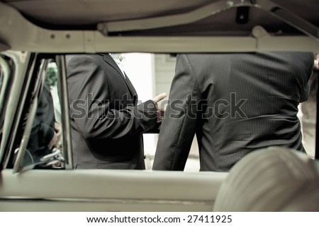 Shot from interior of vintage car of grrom and best man at a wedding