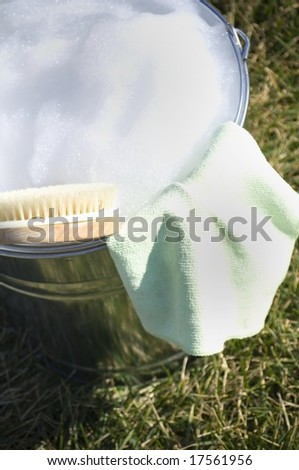 Cleaning cloth in bucket of soapy water