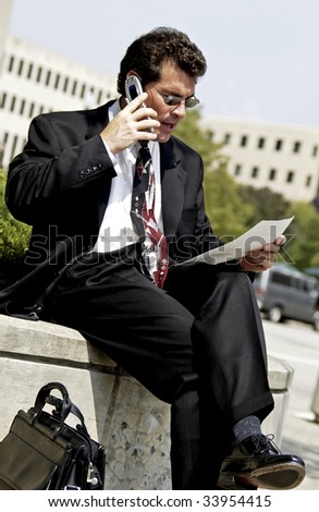 businessman talking on cell phone outside