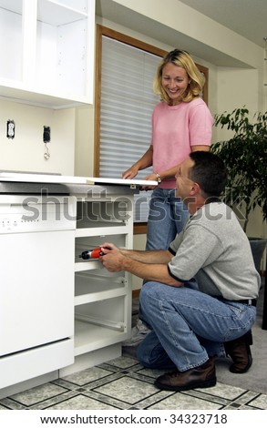 Installing Kitchen Cabinets on Couple Installing Kitchen Cabinet Stock Photo 34323718   Shutterstock