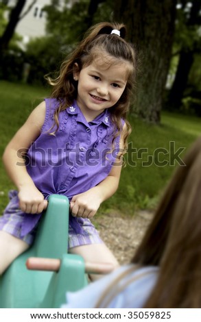 little girl on teeter totter