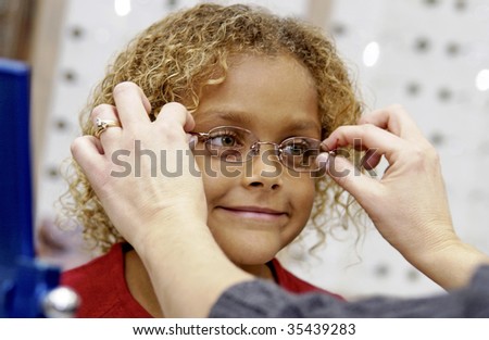 girl trying on eye glasses