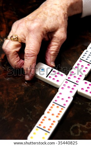 older woman playing dominoes