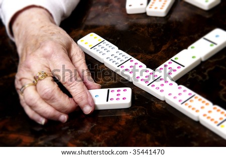 senior woman playing dominoes