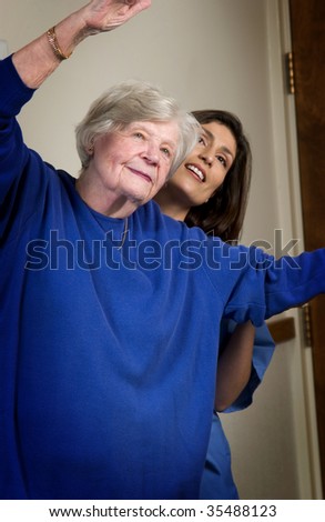 nurse helping senior woman exercise