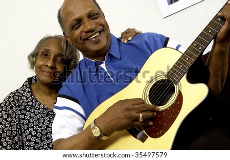 african american couple playing guitar
