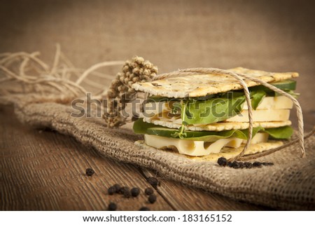 Bread sandwiches with gruyere cheese, cucumber and fresh arugula - healthy eating concept