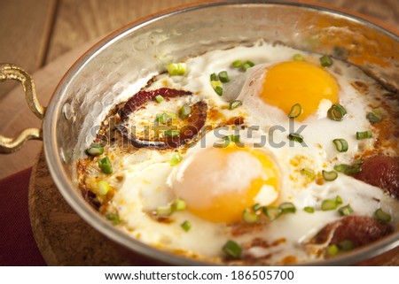 Turkish sausage sucuk with egg in copper pan turkish breakfast meal