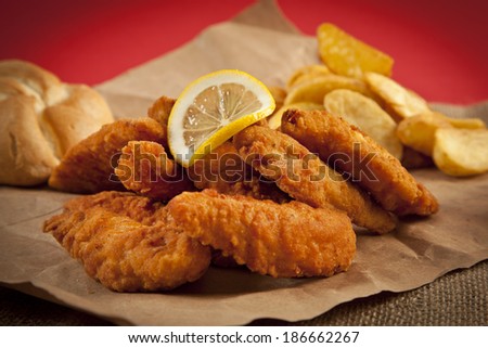Viener chicken fries, breaded steak with french fries, lemon and bread