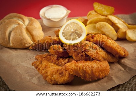 Viener chicken fries, breaded steak with french fries, lemon and bread