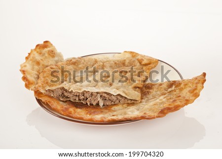 Turkish meat pie fried in oil ( Cig borek ) ( Raw pie or Tatar pie ) isolated white background