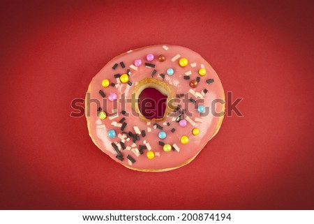 Donut with Pink and Yellow on Red Background