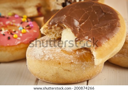Glazed Cream Donut with Bite Missing