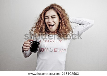 Tired sleepy yawning woman waking up with cup of coffee
