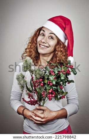 Tired sleepy woman waking up happy with xmas santa hat and christmas flowers