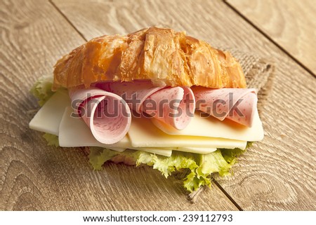 Close up of ham and cheese croissant sandwich.