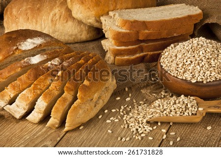 Wheat Bread, wheat seeds and bread slices with wooden background