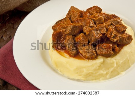 Turkish traditional Tas Kebab Turkish Food potatoes and Meat:. Lamb Stew Served on a Bed of potatoes Puree